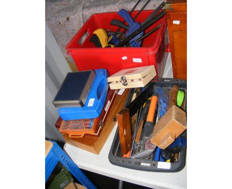A red box with clamps, selection of other boxed and loose tools