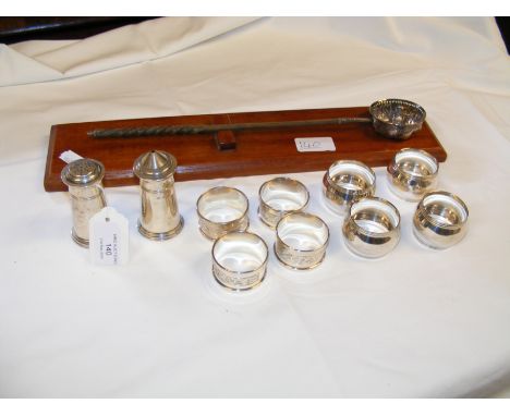 A selection of silver napkin rings, salt and pepper pot, together with a toddy ladle
