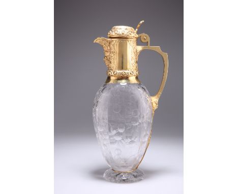 A VICTORIAN SILVER-GILT MOUNTED CUT-GLASS CLARET JUG,&nbsp;by Charles Edwards, London 1882, of flattened pear-form, the mount