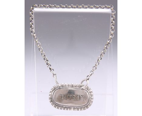 A SMALL GEORGE III SILVER 'PORT' LABEL, by&nbsp;Daniel Hockley, maker's mark only, rounded rectangular with bead and reel bor