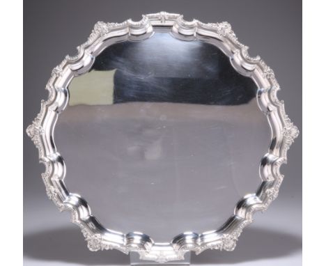 AN ELIZABETH II SILVER SALVER,&nbsp;by&nbsp;W H Manton Ltd, Birmingham 1955, of shaped circular form, raised on three scroll 