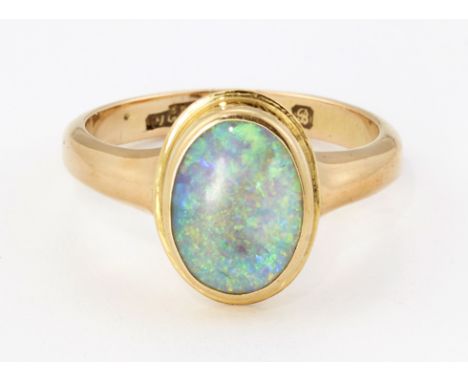 AN 18CT GOLD OPAL RING, an oval opal in a bezel setting, to tapering shoulders, hallmarked Chester 1902, ring size M. 5.1 gra