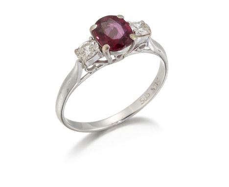 A RUBY AND DIAMOND THREE STONE RING, an oval-cut ruby between oval brilliant-cut diamonds, total estimated diamond weight 0.2