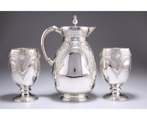 A VICTORIAN SILVER JUG AND PAIR OF GOBLETS, by&nbsp;Richard Martin &amp; Ebenezer Hall, the pitcher 1877, the beakers 1875, r