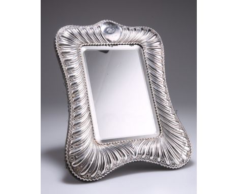 A VICTORIAN SILVER EASEL MIRROR,&nbsp;by William Comyns &amp; Sons,&nbsp;London 1899, shaped rectangular, the gadrooned borde