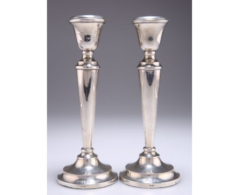 A PAIR OF ELIZABETH II SILVER CANDLESTICKS,&nbsp;by&nbsp;William Adams Ltd,&nbsp;Birmingham 1960, with beaded borders, weight
