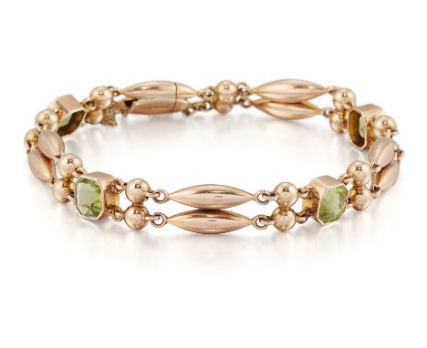AN EDWARDIAN PERIDOT BRACELET, octagonal-cut peridot in bezel settings, spaced by pairs of lozenge and bead links, indistinct