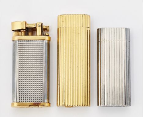 A GROUP OF THREE VINTAGE LIGHTERS, comprising two by Cartier and one by Dunhill. Tallest 7cmCONDITION REPORTWe believe these 