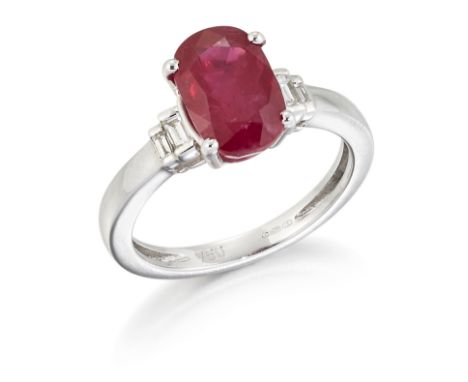 AN 18CT WHITE GOLD RUBY AND DIAMOND RING,&nbsp;an oval-cut ruby in a claw setting, between pairs of baguette-cut diamonds, to