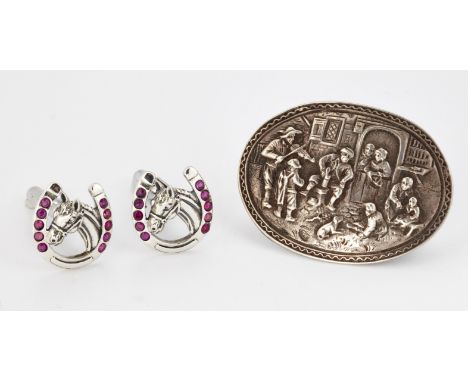 A PAIR OF CUFFLINKS, each as a horses head within a ruby set horseshoe, with hinged backs, marked 'Sterling Silver'; AND A BR
