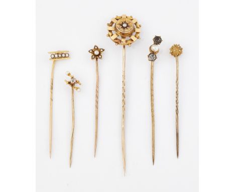 A GROUP OF SIX STICK PINS, including; A DIAMOND AND SEED PEARL SET EXAMPLE; A SEED PEARL STAR EXAMPLE; AND TWO ETRUSCAN REVIV