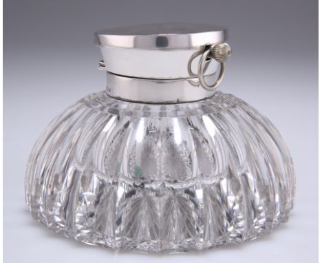 AN EDWARDIAN SILVER-TOPPED CUT-GLASS INKWELL WITH INTEGRAL WATCH, by John Grinsell & Sons, Birmingham 1903, the fluted glass 