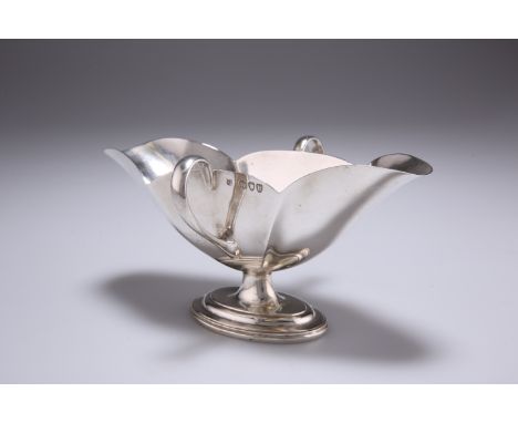A VICTORIAN SILVER DOUBLE-LIP SAUCEBOAT,&nbsp;by Thomas Bradbury &amp; Sons, London 1895, with twin lug handles, raised on a 
