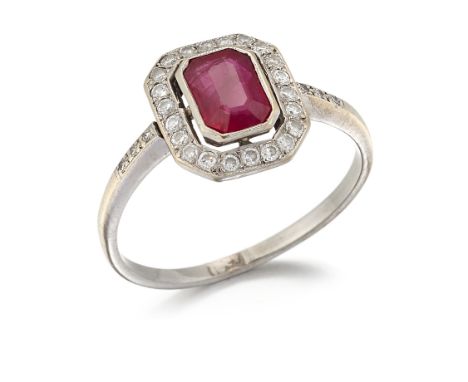 A RUBY AND DIAMOND CLUSTER RING, an octagonal-cut ruby within a conforming halo border of round brilliant-cut diamonds, to di