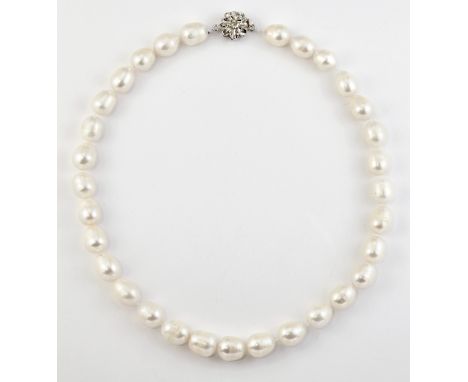 A FRESHWATER PEARL NECKLACE, barrel-shaped pearls knotted to a floral clasp. Length 43cmThe absence of a Condition Report doe
