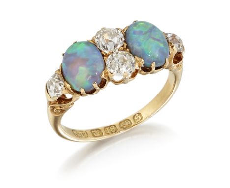 A VICTORIAN 18CT GOLD BLACK OPAL AND DIAMOND RING, two oval opals spaced by four old-cut diamonds, to carved scroll shoulders