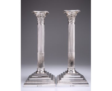 A LARGE PAIR OF EDWARDIAN SILVER COLUMNAR CANDLESTICKS, by William Hutton & Sons Ltd, London 1906 and 1907, each with stop-fl