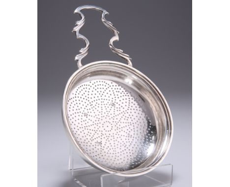 A GEORGE III SILVER LEMON STRAINER, probably by Thomas Shepherd, London 1783, with handle and clip engraved with a crest. 17.