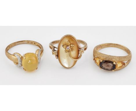 THREE 9CT GOLD GEM-SET RINGS, comprising; A SMOKY QUARTZ AND CITRINE RING, ring size R; A YELLOW CABOCHON AND DIAMOND RING, r