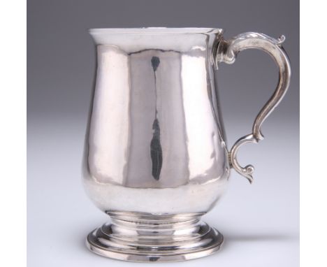 A GEORGE III SILVER MUG,&nbsp;by Hester Bateman, London 1784, of baluster form with reeded spreading foot, the double-scroll 