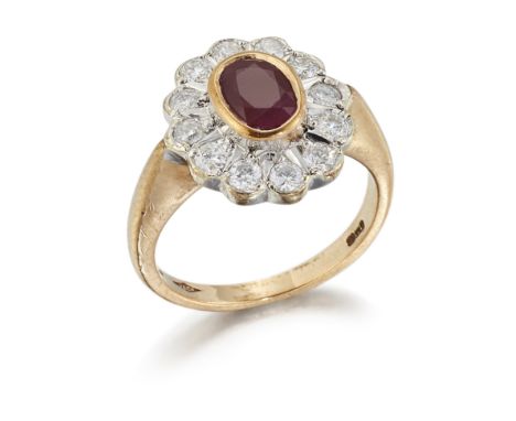 A 9CT GOLD RUBY AND DIAMOND CLUSTER RING, an oval-cut ruby within a border of round brilliant-cut diamonds, to tapering shoul