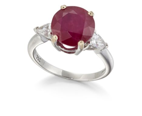 AN 18CT WHITE GOLD RUBY AND DIAMOND THREE STONE RING, a round-cut ruby in a claw setting, between pear-cut diamonds, total es