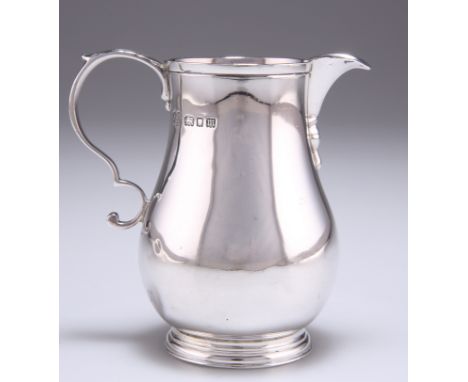 A GEORGE V SILVER CREAM JUG,&nbsp;by James Henry &amp; Herbert Barraclough, London 1927, baluster form, with leaf-capped doub