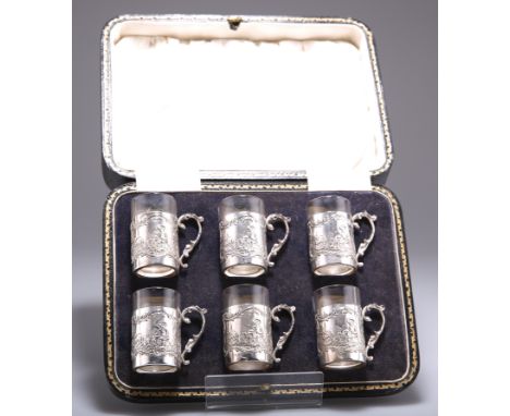 A SET OF SIX GEORGE V SILVER TOT CUPS,&nbsp;by&nbsp;James Dixon &amp; Sons Ltd, Sheffield 1926, each silver sleeve chased wit