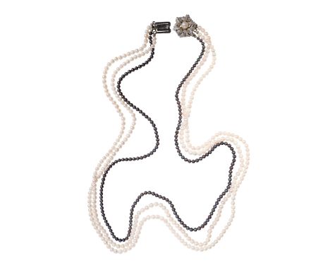 TRIPLE STRAND SEED PEARL NECKLACE, two white strands, one dark blue with grey hues, terminating onto a white metal clasp stam