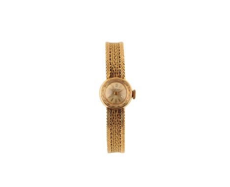 LEUBA LOUIS 18CT GOLD LADY'S BRACELET WATCH, circa 1950's, with a manual wind movement, the silver dial with gold baton numer