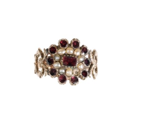 19th CENTURY GARNET AND SEED PEARL RING, on an unmarked yellow metal shank, with cut-out shoulders, ring size L