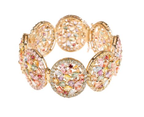 GEM SET HINGED BANGLE, eight oval openwork links, set with various gem stones, the concealed clasp with safety hooks, stamped