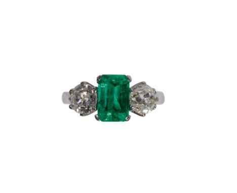 EMERALD AND DIAMOND RING, the Colombia mine emerald, 1.75ct, flanked either side by a brilliant cut diamond, approx 2.03ct to