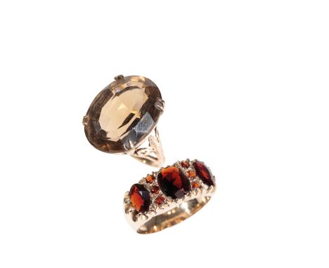 GARNET DRESS RING AND SMOKEY QUARTZ RING, both on yellow gold shanks, ring size P &amp; K