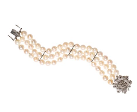 TRIPLE STRAND CULTURED PEARL BRACELET WITH DIAMOND CLUSTER CLASP, each pearl knotted, divided with three unmarked white metal