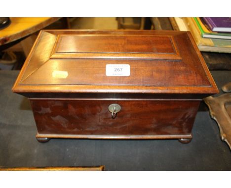A 19th Century mahogany sarcophagus shaped tea caddy and contents of various glasses