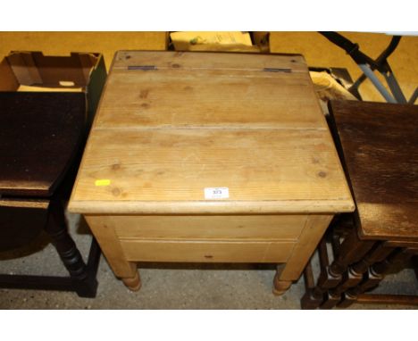 A stripped pine commode