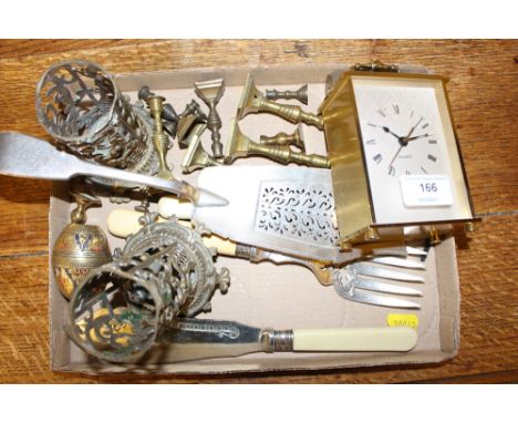 A tray of small brass items to include candlesticks; a mantel clock etc. together with a fish serving knife and fork etc.