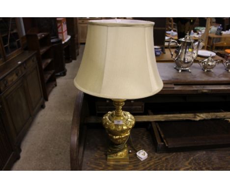 A gilt metal table lamp and silk shade