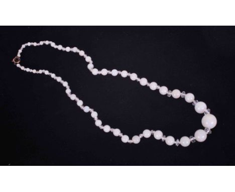 A graduated string of white opal beads interspaced with faceted glass beads, the largest opal bead is approx. 13.5mm down to 