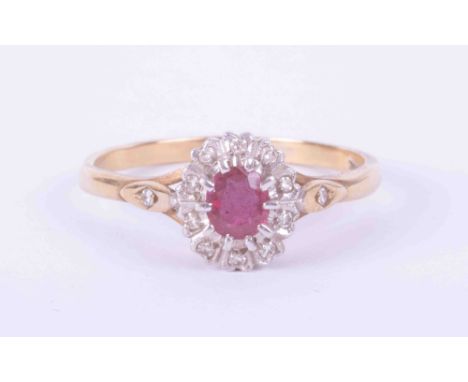 A 9ct yellow &amp; white gold cluster ring set approx. 0.35 carats of ruby surrounded with small diamonds and a small diamond