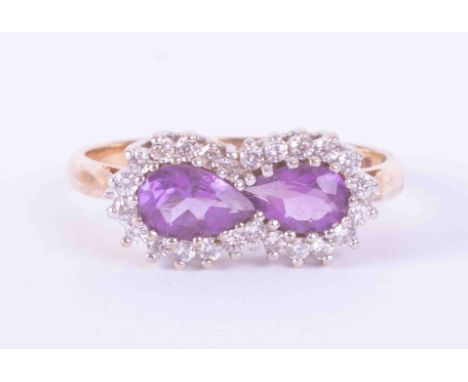 A 9ct yellow &amp; white gold cluster ring set two pear shaped amethysts weight approx. 0.85 carats total surrounded by appro