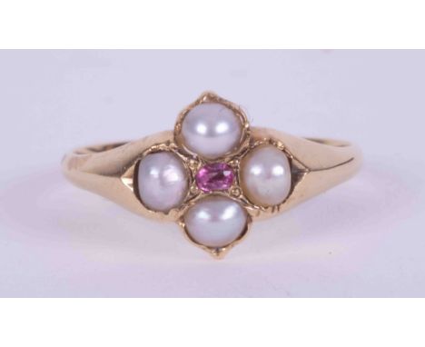 An antique gold ring (gold not tested) set with four small pearls and a small central set oval cut ruby, weight 1.58g, size K