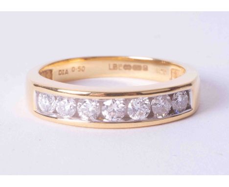 An 18ct yellow gold channel set half eternity ring set 0.50 carats of round brilliant cut diamonds, colour G-H and SI clarity