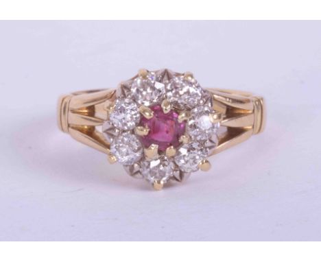 An 18ct yellow gold split shoulder cluster ring set central ruby approx. 0.25 carats, surrounded by approx. 1.20 carats of ol