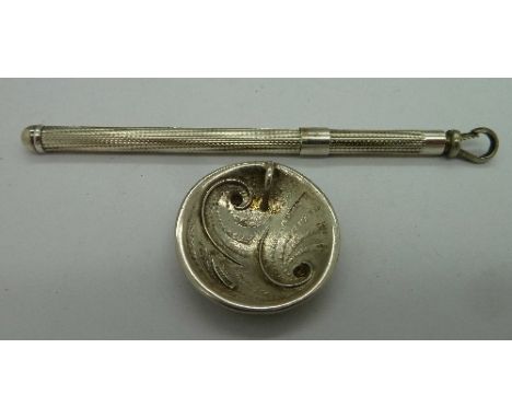 A silver swizzle stick and a silver pendant