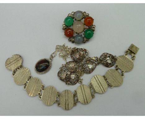 A Scottish hardstone brooch, two silver bracelets and a silver portrait pendant and chain