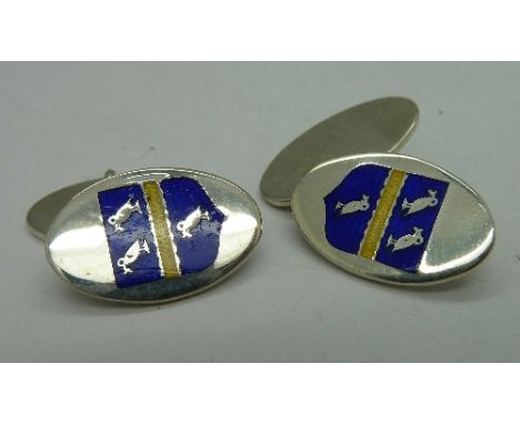A pair of silver and enamel cufflinks