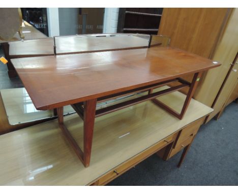 A vintage teak coffee table with undertier