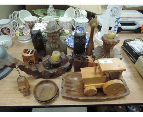 A selection of wooden figures and carved items including Owl book ends and chamber stick